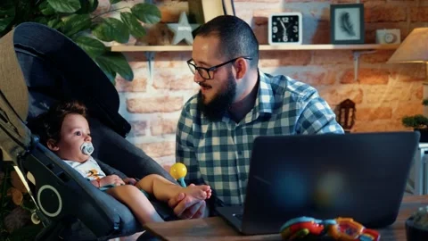 Young programmer takes care of his son  working from home Stock Footage 156795558