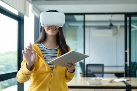 Young programmer with virtual reality glasses to testing 3D application. Stock Photos