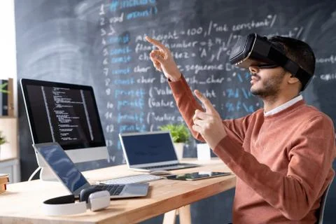 Young programmer in vr headset testing or presenting new software Stockfoto's