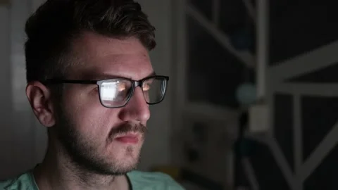 Young programmer wearing glasses is using a computer Stock Footage 166750634
