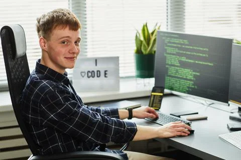 Young programmer working with codes on computer Stockfoto's
