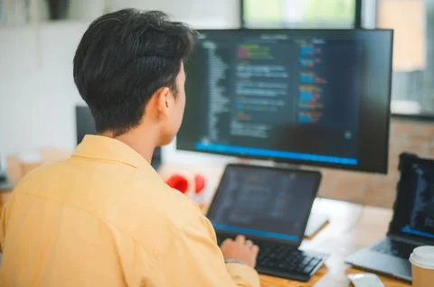 Young programmer working on coding, software development and web design in .. 스톡 사진