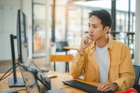 Young programmer working on coding, software development and web design in .. Stock Photos