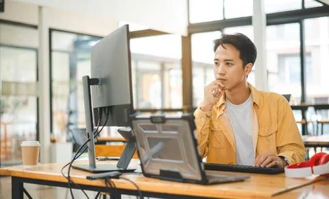 Young programmer working on coding, software development and web design in .. 写真素材