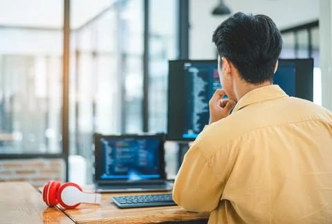 Young programmer working on coding, software development and web design in .. 스톡 사진