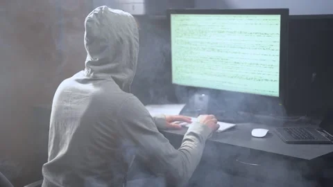 Young programmer working on a computer and smoke on background. Operator Typing Stock Footage 131896884