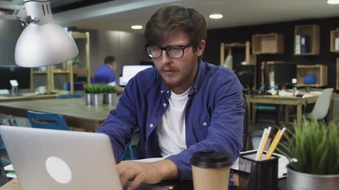 Young programmer working on computer in office Stock Footage 121772649