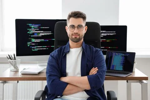 Young programmer working at desk in office 库存照片