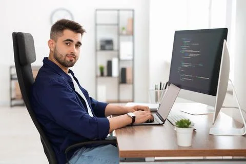 Young programmer working at desk in office 写真素材