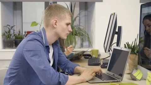Young programmer working with laptop Stock Footage 72575033