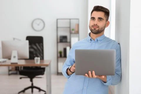 Young programmer working with laptop in office 写真素材