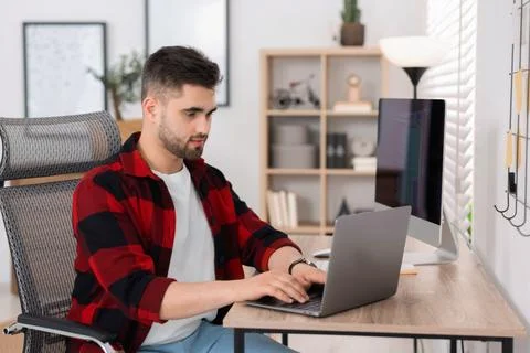 Young programmer working with laptop in office Stock Photos