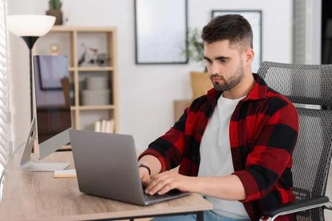 Young programmer working with laptop in office 写真素材
