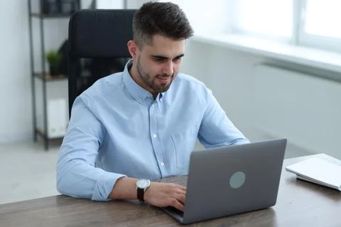 Young programmer working with laptop in office 스톡 사진