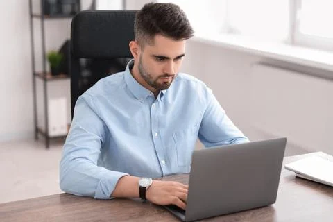 Young programmer working with laptop in office Stock Photos