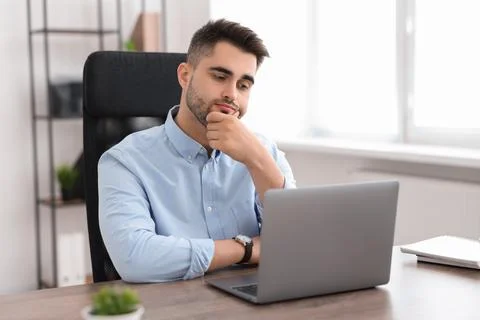 Young programmer working with laptop in office 写真素材