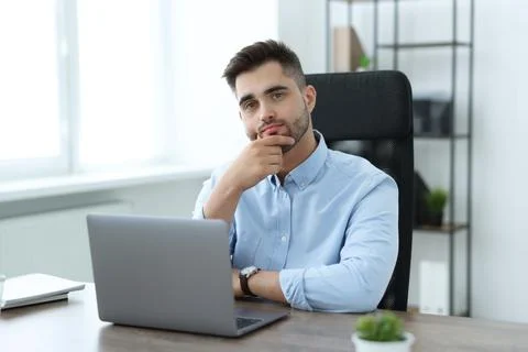 Young programmer working with laptop in office 写真素材