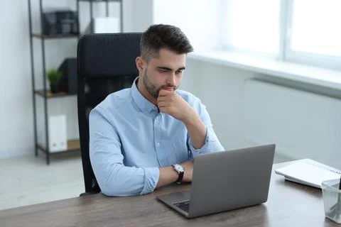 Young programmer working with laptop in office 写真素材