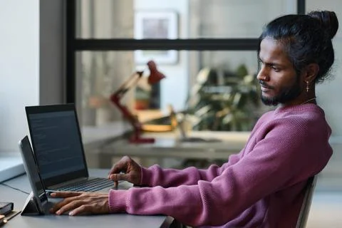 Young programmer working online with gadgets Stock Photos