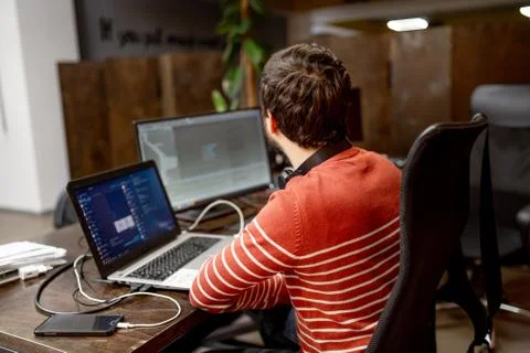 Young programmer at workplace. Startup business. Program development concept. 스톡 사진