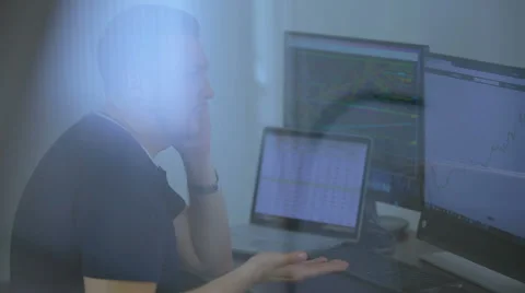 The young programmer works behind the laptop and speaks by phone Stock Footage 62519103