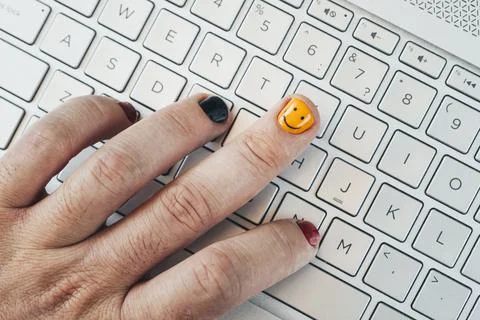 A young programmer works at a computer. Painted nails close-up. fashionable p Stock Photos
