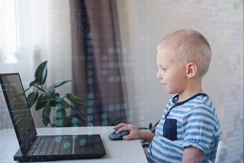 Young programmer writing code on a computer at home. Programming lessons for 写真素材
