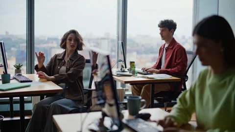 Young programmers coding computers sitting together at spacious coworking zone Stock Footage 319772283