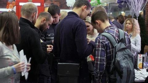 Young programmers communicate with the employer during open vacancies fair in Hi Stock Footage 102436447