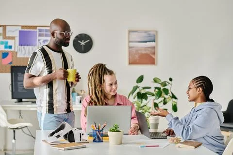 Young programmers discussing project in team Fotos Stock