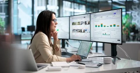 Young Property Manager Using Laptop To Track Rental Income And Maintenance Re Stock Photos
