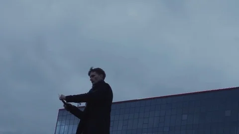 Young protester man Igniting and throwing Molotov cocktail bottle storm clouds Stock Footage 74364067