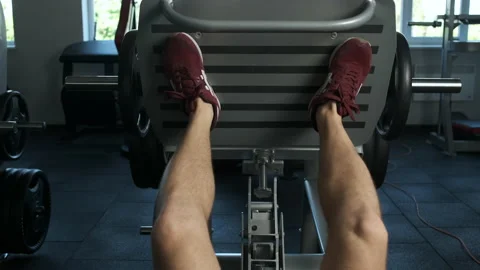 A young pumped-up athlete does another leg exercise in the gym in preparation Stock Footage 135305815