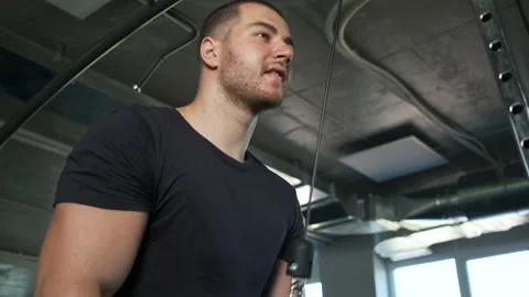 Young pumped-up athlete doing another biceps exercise at the gym in preparation Stock Footage 135305012
