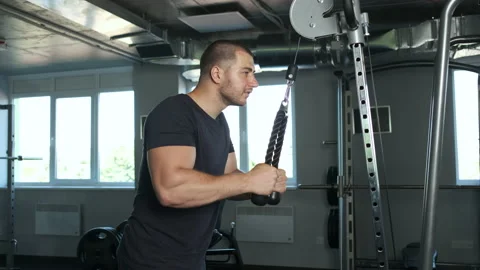 Young pumped-up athlete doing another biceps exercise at the gym in preparation Video stock 136819980