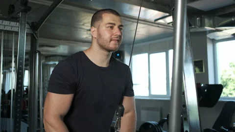 Young pumped-up athlete doing another biceps exercise at the gym in preparation Stock Footage 139042707
