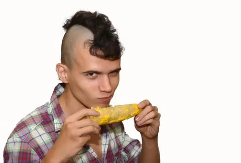 Young punk eats a corn. Stock Photos