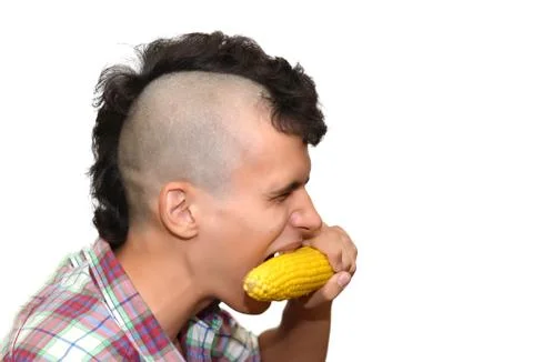Young punk eats a corn. Stock Photos