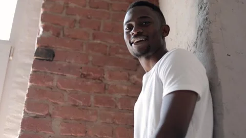 A young rapper reads hip hop to the camera near a brick wall. Stock Footage 203971453
