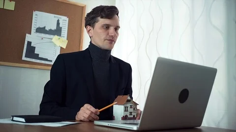 Young real estate agent having video call with customer using laptop Stock Footage 79901373