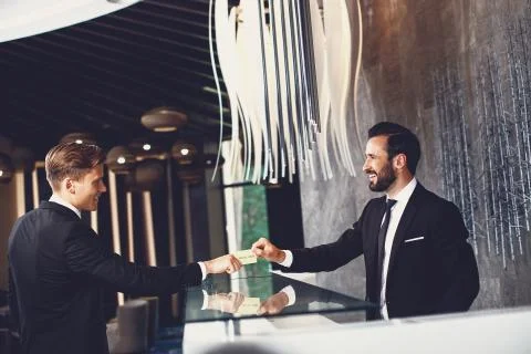 Young receptionist looking confident while working with client Stock Photos