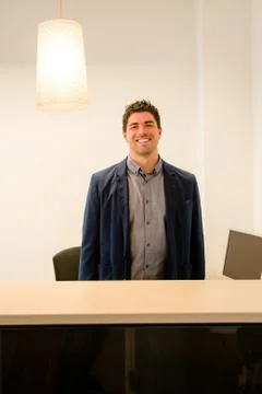 Young receptionist smiling Stock Photos