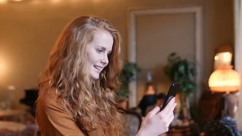Young Red Hair Caucasian Woman Using Smart Phone Technology In Cafe Stock Footage 98572722