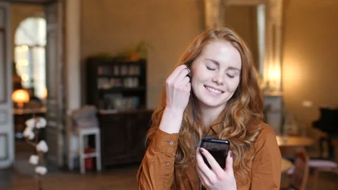 Young Red Hair Caucasian Woman Listens To Music On Phone And Dances In Cafe Stock Footage 98576746