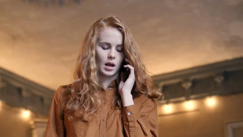 Young Red Hair Caucasian Woman Seriously Talking On Cell Phone In Cafe Stock Footage 98578148