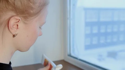 Young red-haired applies lotion on face with hand standing Stock-Footage 128763330