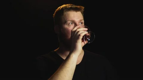 Young red-haired man with a beard drinks konchak from a konchachny glass  Stock Footage 169011910