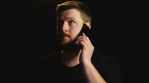 Young red-haired man with a beard talking on the phone Stock Footage 169012088