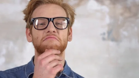 Young red-haired man isolated on painted wall in eyeglasses smiling happy Stock Footage 121646783