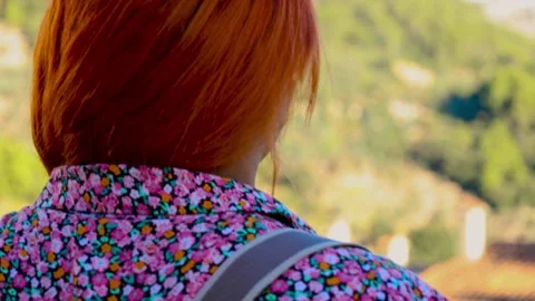 Young red haired woman looking at the beautiful village of Valldemossa Video stock 282969214
